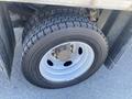 Close-up of a tire mounted on a silver rim featuring deep tread patterns on a Ford F-450 SD vehicle