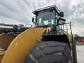A 2012 Caterpillar 980 front loader with a large bucket and thick tires is shown facing the viewer with its cab prominently visible