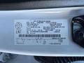 A 2020 Ford F-350 engine compartment with a visible identification label detailing specifications and vehicle information
