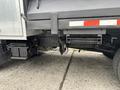 Close-up of a 2015 Mitsubishi Fuso FE160 truck chassis showing the undercarriage with components like the exhaust and hitch attachments
