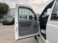 A 2014 Ford F-550 with the driver's side door open, revealing the interior with a gray panel and seats