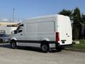 A white 2020 Mercedes-Benz Sprinter van with a high roof and rear cargo door parked on the street