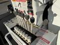 Control levers and switches on a 2011 International 7500 truck's hydraulic system with labels indicating caution and danger