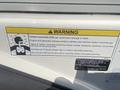 Warning label on a 2013 Larson 238 boat detailing the dangers of carbon monoxide exposure and safety instructions for the engine and generator exhaust