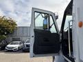 2012 International DuraStar 4300 with the driver's side door open revealing the interior and mirror