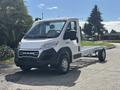 A 2023 RAM Promaster 3500 chassis cab in white with a front grille displaying the RAM logo and five headlights on the roof