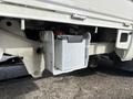 A gray battery mounted on the chassis of a 2010 Daihatsu Hijet