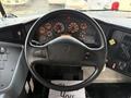 The dashboard of a 2013 International 4300 featuring a steering wheel with controls and an array of gauges and indicators displaying various functions and information