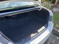 The trunk of a 2015 Hyundai Sonata is open revealing a spacious and clean interior without any items inside