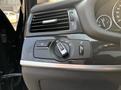A close-up view of the headlight control knob in a 2013 BMW X3 featuring various settings for headlights and fog lights