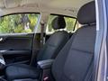 Interior of a 2018 Kia Rio5 showing two black fabric front seats with seat adjustments and armrest