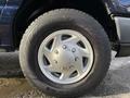 Close-up of a silver wheel with a distinct five-spoke design mounted on a black tire labeled Hankook and Dugartro A5