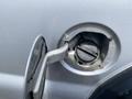 Close-up of the fuel filler cap on a silver 2007 Ford F-350 SD revealing the opening for refueling