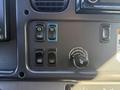 Control panel of a 2017 Freightliner M2 106 featuring buttons for light test mirror heat fog lamp and vehicle suspension settings