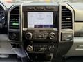A 2020 Ford F-350 SD dashboard displaying the audio control panel with a touch screen and various knobs for media and climate adjustments