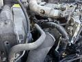 Close-up view of the engine components of a 2014 Hino 195 showing hoses wires and a metallic structure