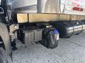 A 2018 Hino 195 truck with an exposed undercarriage showcasing a battery and a fluid reservoir attached to the side