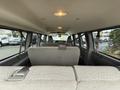 Interior view of a 2021 Chevrolet Express with rows of bench seats and overhead lights visible