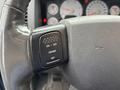Close-up of the cruise control buttons on a steering wheel of a 2006 Dodge Ram 2500 showing On Off Cruise and Set options