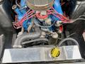 Engine compartment of a 1968 Ford Mustang Two Door Convertible featuring a blue engine block red wiring and various components including belts and hoses