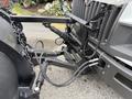 Close-up of the front attachment system of a 2012 International TerraStar featuring hydraulic lines and a metal framework for mounting a plow or other equipment