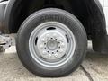 A close-up of a silver wheel and tire from a 2012 Dodge Ram 4500 featuring a Continental tire with a series of bolts in the center of the wheel