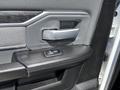 Interior door handle and window control of a 2021 RAM 5500 with a dark textured finish and metallic accents