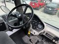 Interior view of a 2012 Global M4 dashboard showing the steering wheel control panel gauges and various buttons