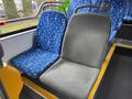 Interior seating of a 2018 Grande West Vicinity bus featuring a blue patterned seat and a gray textured seat
