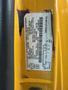 A yellow 2021 Ford Econoline with a label containing vehicle information and specifications located on the driver's side door jamb