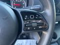 Close-up of the control panel on the steering wheel of a 2024 Mercedes-Benz Sprinter 2500 featuring buttons for volume navigation and phone functions