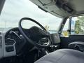 Interior view of a 2011 International 4300 truck showing the steering wheel dashboard and driver seat
