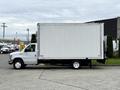 2019 Ford Econoline box truck with a white exterior parked on a concrete surface featuring a large cargo box at the back