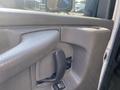 Close-up of the door handle and controls on the interior of a 2011 Chevrolet Express van