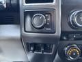 Control panel of a 2017 Ford F-550 with switches and dials for drive modes and audio controls