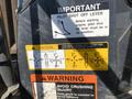 Close-up of a control panel on a 2022 John Deere equipment featuring several safety and operating instructions including pilot shut off lever and caution labels for operating patterns