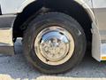 Close-up of a shiny wheel hub and tire on a 2020 Chevrolet Express showing intricate chrome detailing and a rugged tire tread design