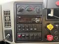 Dashboard controls of a 2016 International 7400 featuring various buttons knobs and an audio system