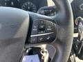 Close-up of the steering wheel controls for a 2025 Ford Transit T-350 featuring buttons for back, OK, menu, and phone functions