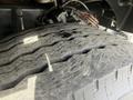 Close-up of a tire from a 2016 Freightliner 108SD showing worn tread patterns and signs of use