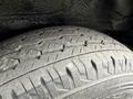 A close-up view of a tire from a 2009 Toyota Hiace displaying tread patterns and details of the rubber surface