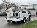 2012 Ford F-450 SD utility truck with a rear-mounted boom lift and utility box designed for maintenance and service tasks