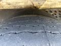 Close-up of a worn tire from a 2011 Autocar Xpeditor showing visible tread wear and grooves on the surface