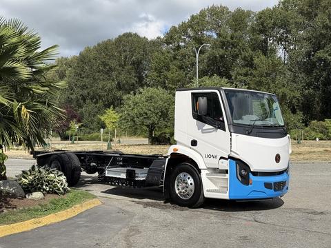 A 2022 Lion Lion6 truck with a white cab and blue accents is parked, featuring a chassis without a freight box