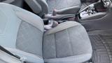 Interior view of a 2019 Nissan Kicks showcasing the front seats with a black and gray color scheme and textured fabric upholstery