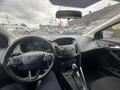 Interior view of a 2018 Ford Focus featuring a modern dashboard with digital speedometer center console and gear shifter
