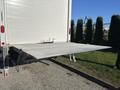 A 2022 Lion Lion6 with a lowered hydraulic lift gate extended from the rear for cargo loading and unloading