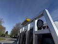 A 2021 Ford F-250 SD with a metal rack featuring a yellow light bar and a black work light mounted on top