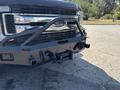 Black 2017 Ford F-550 front bumper with a rugged push bar and multiple hitch receiver openings