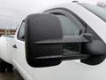 Close-up of the side mirror of a 2013 Chevrolet Silverado 3500HD covered in raindrops with a black plastic casing